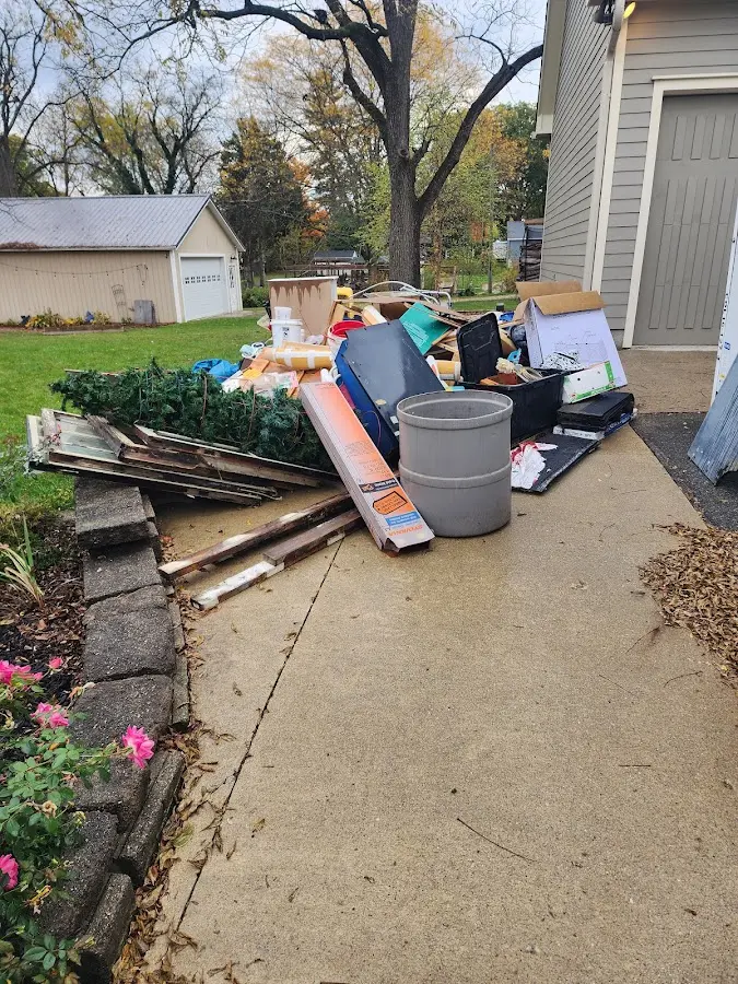 Dumpster being loaded with debris for Roofing Dumpster Rental in Shaker Heights